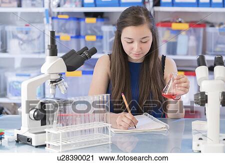 Stock Image - Girl making notes. Fotosearch