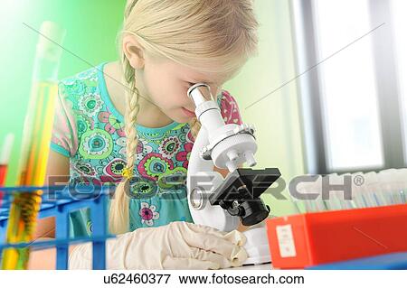 Stock Photo - Girl pretending to be scientist looking through microscope. Fotosearch