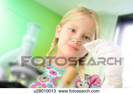 Girl pretending to be scientist examining test tube View Large Photo Image Stock Image - Girl pretending to be scientist examining test tube. Fotosearch