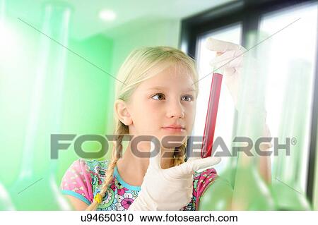 Stock Image - Girl pretending to be scientist examining test tube. Fotosearch