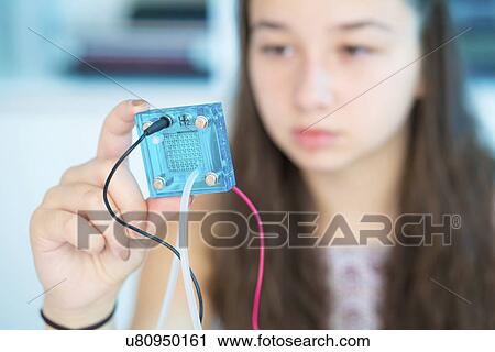 Girl testing proton exchange membrane cell View Large Photo Image Stock Image - Girl testing proton exchange membrane cell. Fotosearch