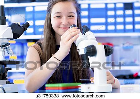 Girl using microscope View Large Photo Image Stock Photo - Girl using microscope. Fotosearch