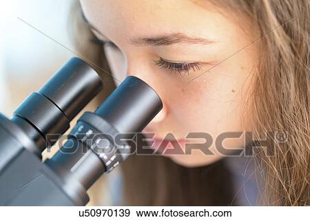 Stock Photo - Girl using microscope. Fotosearch