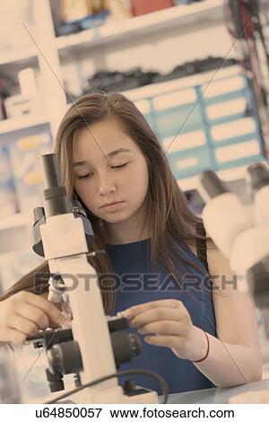 Stock Photo - Girl using microscope. Fotosearch