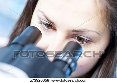 Stock Photo - Girl using microscope. Fotosearch