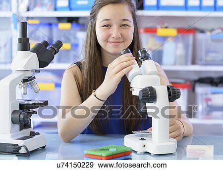 Stock Photo - Girl using microscope. Fotosearch