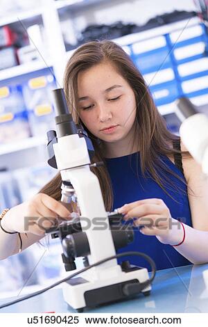 Stock Photography - Girl using microscope. Fotosearch