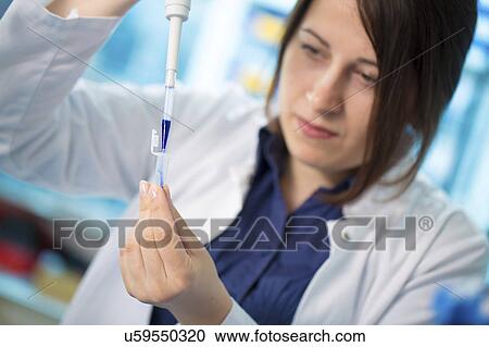 Stock Image - Girl using pipette. Fotosearch