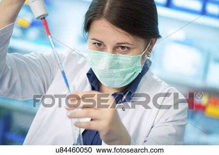 Girl wearing mask holding test tube View Large Photo Image Stock Image - Girl wearing mask holding test tube. Fotosearch
