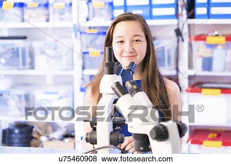 Girl with microscope View Large Photo Image Stock Photo - Girl with microscope. Fotosearch