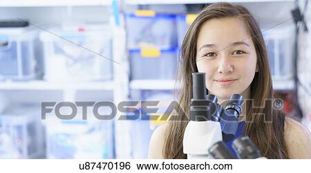 Girl with microscope View Large Photo Image Stock Photograph - Girl with microscope. Fotosearch