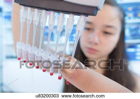 Stock Image - Girl with pcr tubes. Fotosearch