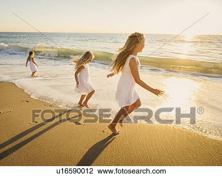Girls (4-5, 6-7, 8-9) running on beach View Large Photo Image Stock Image - Girls (4-5, 6-7, 8-9) running on beach. Fotosearch