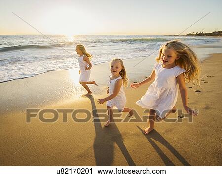 Girls (4-5, 6-7, 8-9) running on beach View Large Photo Image Stock Image - Girls (4-5, 6-7, 8-9) running on beach. Fotosearch