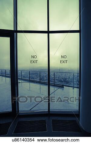 Picture - Glass doors with 'no entry' and view of city. Fotosearch