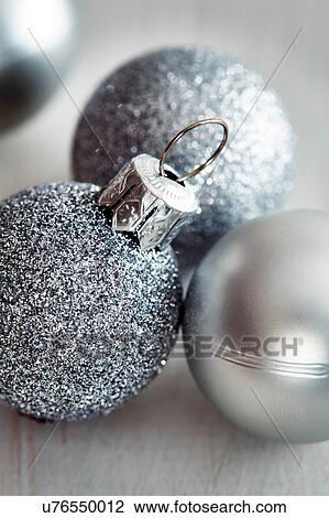 Stock Image - Glittery silver christmas baubles. Fotosearch