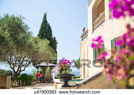 Guests and waitress serving outside boutique hotel, Majorca, Spain View Large Photo Image Stock Image - Guests and waitress serving outside boutique hotel, Majorca, Spain. Fotosearch