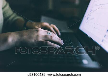 Hand of young woman typing on laptop View Large Photo Image Stock Photo - Hand of young woman typing on laptop. Fotosearch