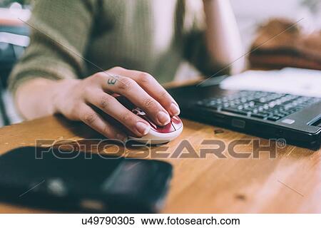 Hand of young woman using laptop mouse View Large Photo Image Stock Photography - Hand of young woman using laptop mouse. Fotosearch