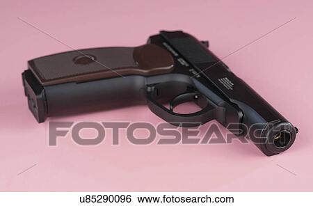 Handgun against a pink background View Large Photo Image Stock Photograph - Handgun against a pink background. Fotosearch