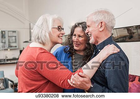 Stock Photo - Happy seniors chatting at home. Fotosearch