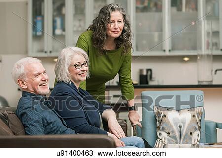 Stock Image - Happy seniors relaxing at home. Fotosearch