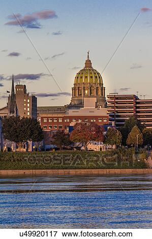 Stock Photo - HARRISBURG, PENNSYLVANIA, City skyline and State Capitol shot at dusk from Susquehanna River. Fotosearch