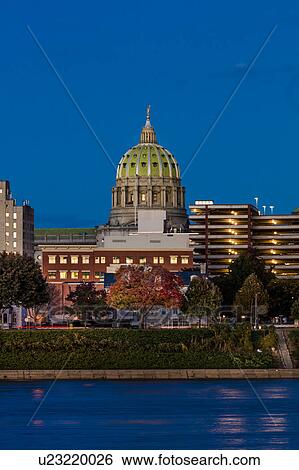 Stock Photograph - HARRISBURG, PENNSYLVANIA, City skyline and State Capitol shot at dusk from Susquehanna River. Fotosearch