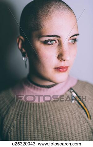 Head and shoulder portrait of blue eyed young woman with shaved head View Large Photo Image Stock Image - Head and shoulder portrait of blue eyed young woman with shaved head. Fotosearch