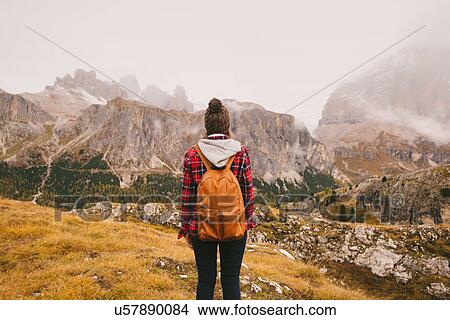 Picture - Hiker looking out at Mount Lagazuoi, Dolomite Alps, South Tyrol, Italy. Fotosearch