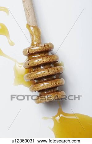 Honey dripper on white surface View Large Photo Image Stock Image - Honey dripper on white surface. Fotosearch