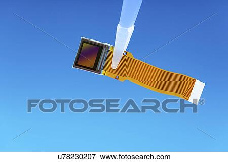 Stock Photo - Image sensor held by tweezers. Fotosearch