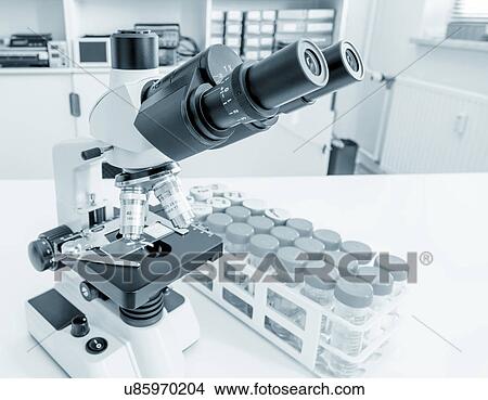 Picture - Laboratory microscope and test tubes. Fotosearch