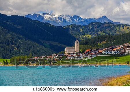 Stock Photography - Landscape view of lake and village in Vinschgau Valley, South Tyrol, Italy. Fotosearch