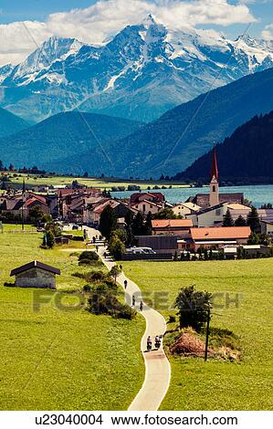 Landscape view of village and snow capped mountains in Vinschgau Valley, South Tyrol, Italy View Large Photo Image Picture - Landscape view of village and snow capped mountains in Vinschgau Valley, South Tyrol, Italy. Fotosearch