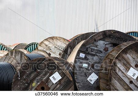 Large group of wooden cable drums in industrial yard View Large Photo Image Stock Photograph - Large group of wooden cable drums in industrial yard. Fotosearch