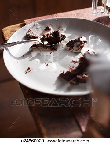 Stock Image - Leftover chocolate pudding on plate. Fotosearch