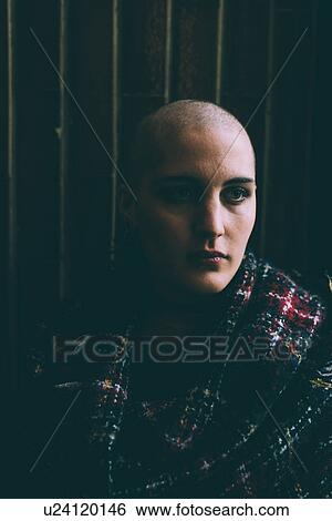 Low key portrait of young woman with shaved head View Large Photo Image Stock Photograph - Low key portrait of young woman with shaved head. Fotosearch