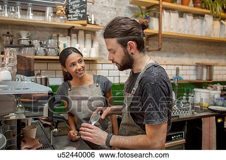 Male and female baristas preparing coffee in cafe View Large Photo Image Stock Photograph - Male and female baristas preparing coffee in cafe. Fotosearch