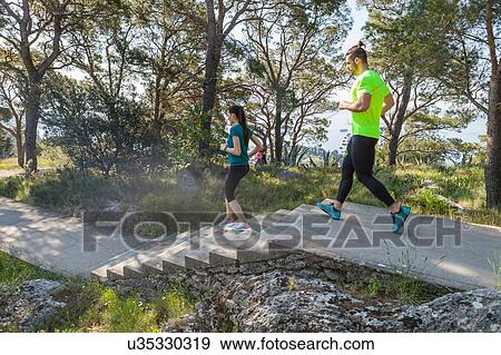 Male and female runners running down park stairway, Split, Dalmatia, Croatia View Large Photo Image Stock Photo - Male and female runners running down park stairway, Split, Dalmatia, Croatia. Fotosearch