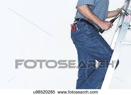 Stock Photography - Man climbing on ladder. Fotosearch