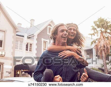 Man giving girlfriend piggyback on street, Cape Town, South Africa View Large Photo Image Stock Image - Man giving girlfriend piggyback on street, Cape Town, South Africa. Fotosearch