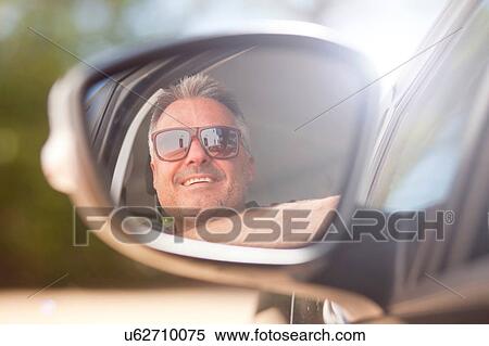 Man looking out of car window View Large Photo Image Stock Photography - Man looking out of car window. Fotosearch