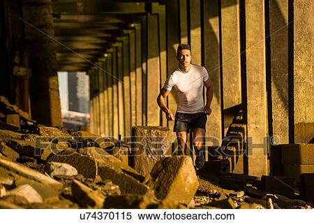 Man running under bridge, Wapping, London, UK View Large Photo Image Stock Photography - Man running under bridge, Wapping, London, UK. Fotosearch