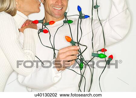 Mature couple wrapped in christmas lights View Large Photo Image Stock Image - Mature couple wrapped in christmas lights. Fotosearch