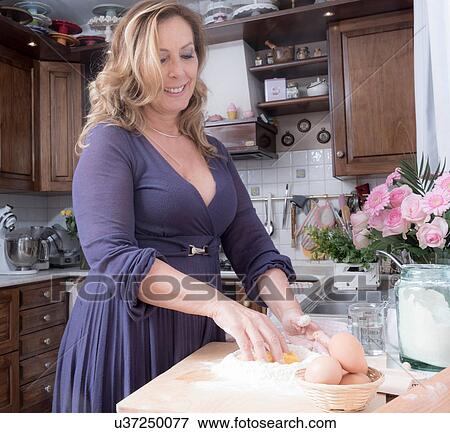 Mature woman preparing pasta in traditional Italian kitchen View Large Photo Image Stock Photo - Mature woman preparing pasta in traditional Italian kitchen. Fotosearch