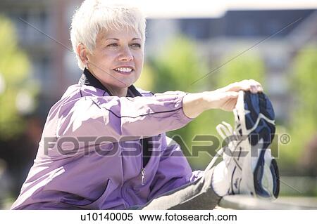 Mature woman working out outdoors View Large Photo Image Stock Photography - Mature woman working out outdoors. Fotosearch