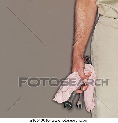 Mechanic holding wrenches and towel View Large Photo Image Stock Image - Mechanic holding wrenches and towel. Fotosearch