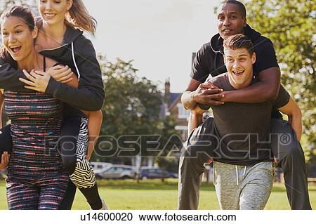 Men and women having fun training in park, having piggy back race View Large Photo Image Stock Image - Men and women having fun training in park, having piggy back race. Fotosearch