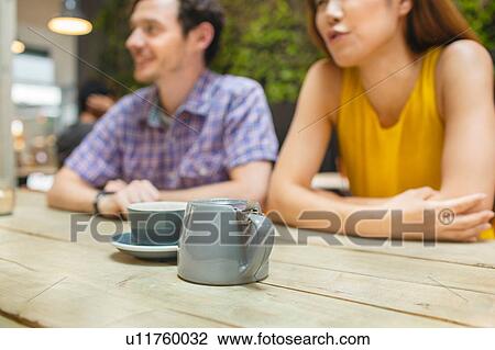 Mid adult couple at coffee shop table View Large Photo Image Stock Image - Mid adult couple at coffee shop table. Fotosearch